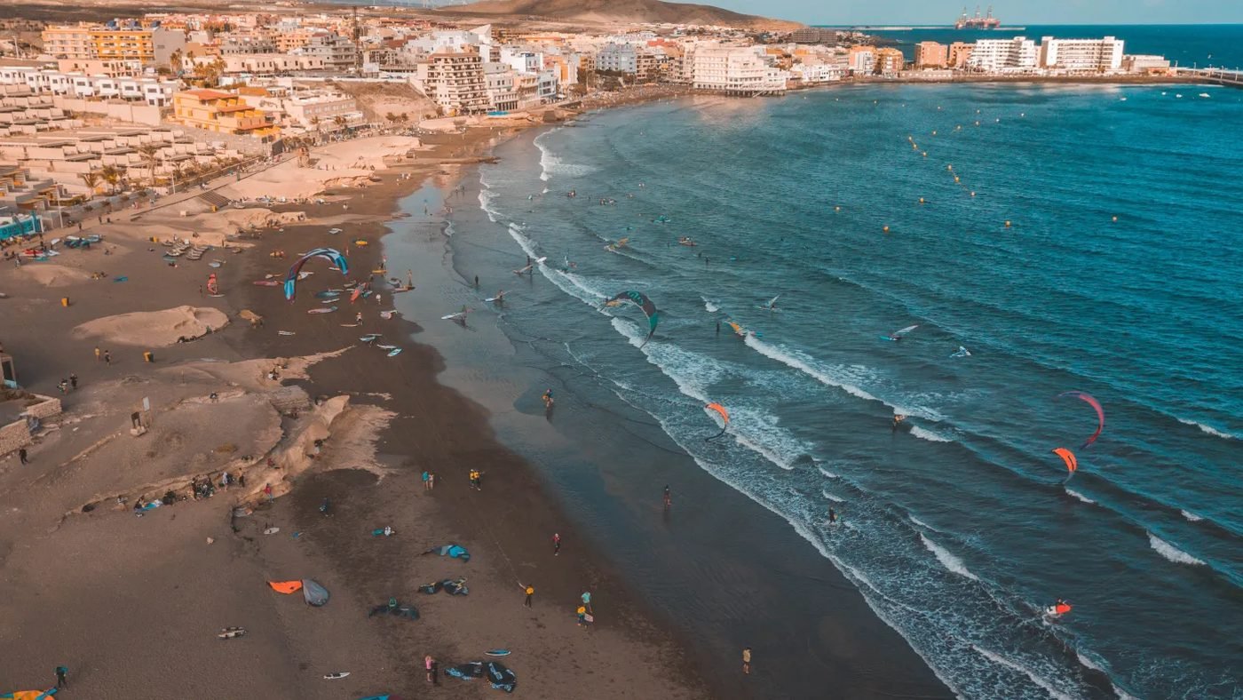 Aerial view of El M&eacute;dano beach, busy with kites and boards